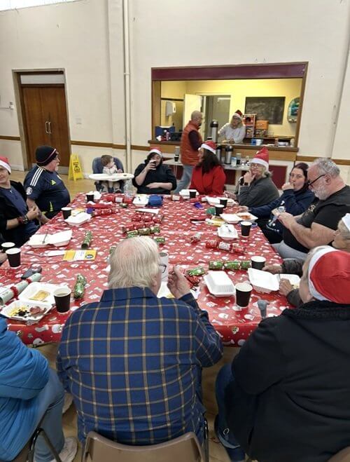 Warm spaces, Linton Lane people sitting round a table eating
