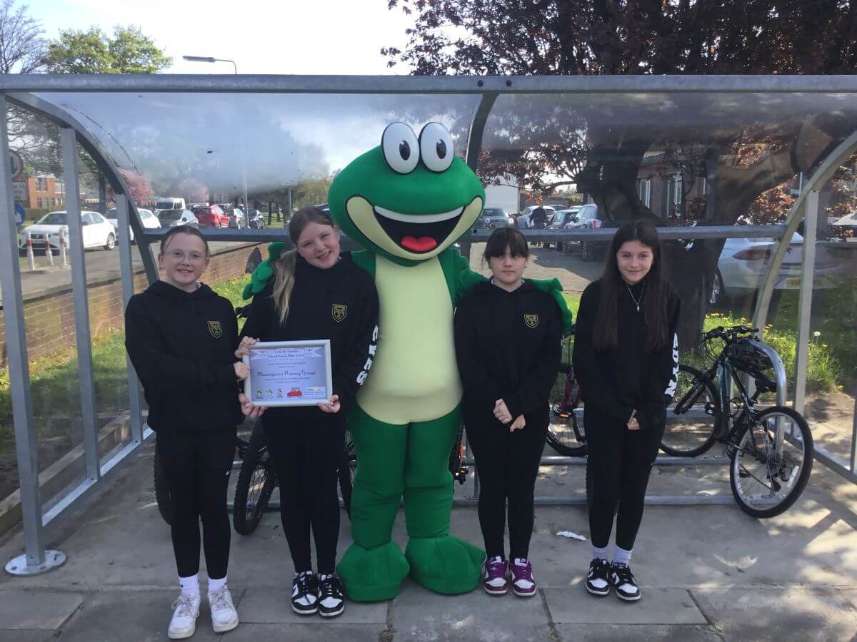 Mountfleurie Primary Fresh Air Frankie standing with pupils in front of Mountfleurie Primary school bike shelter