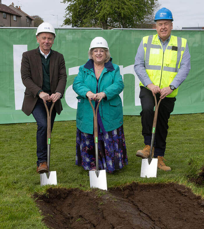 Works starts on Templehall Community Hub, Kirkcaldy Cllrs Ian Cameron and Linda Erskine with Martin Cooper from BAM. All are wearing hard hats and holding silver shovels for the sod cutting event for the new Templehall Community Hub in Kirkcaldy