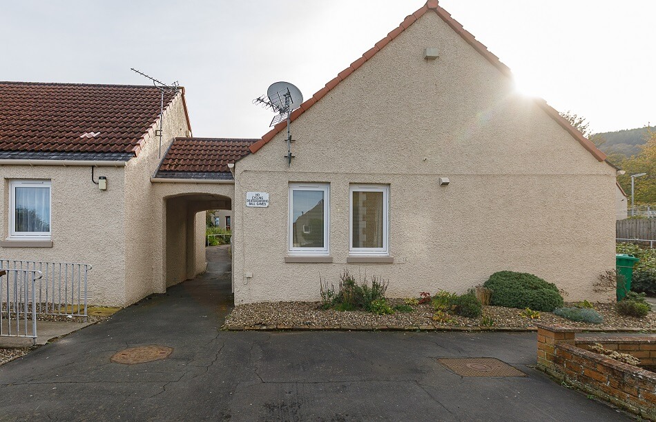 Back of bungalows at Castle Park, with communal walkway adjoining them
