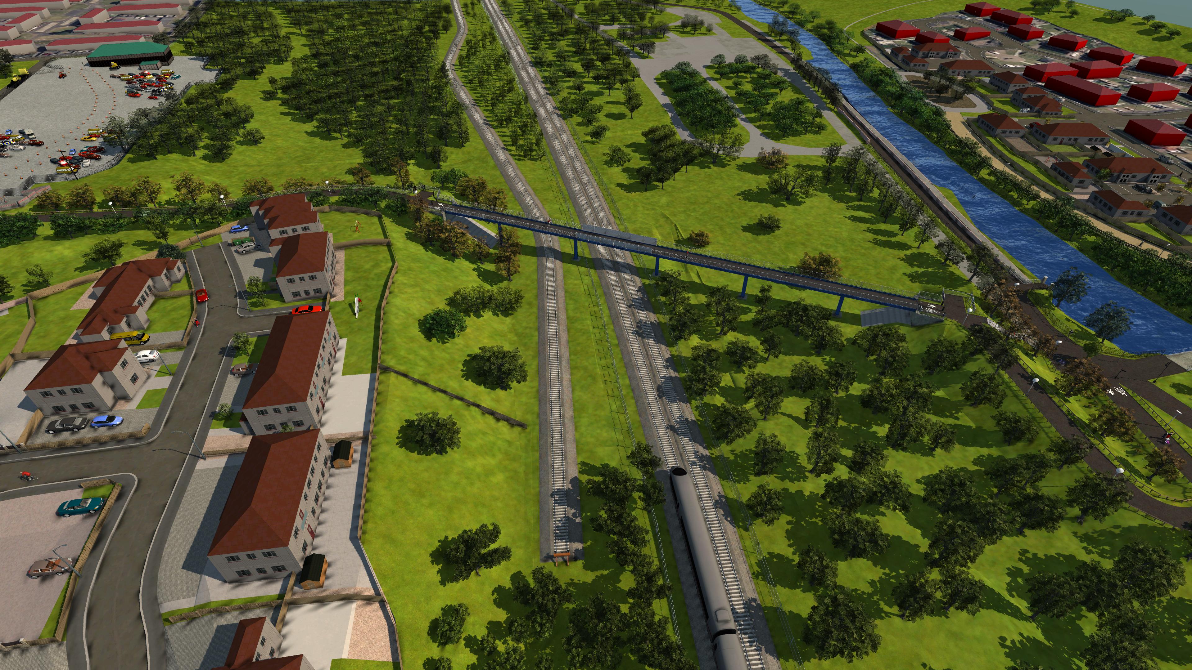 3d visualisation of an aerial view of a train track crossing a road with a bridge over the tracks. There are houses and trees surrounding the area.