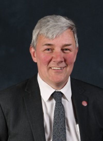 Portrait photograph of Cllr. Altany Craik in a suit and tie.