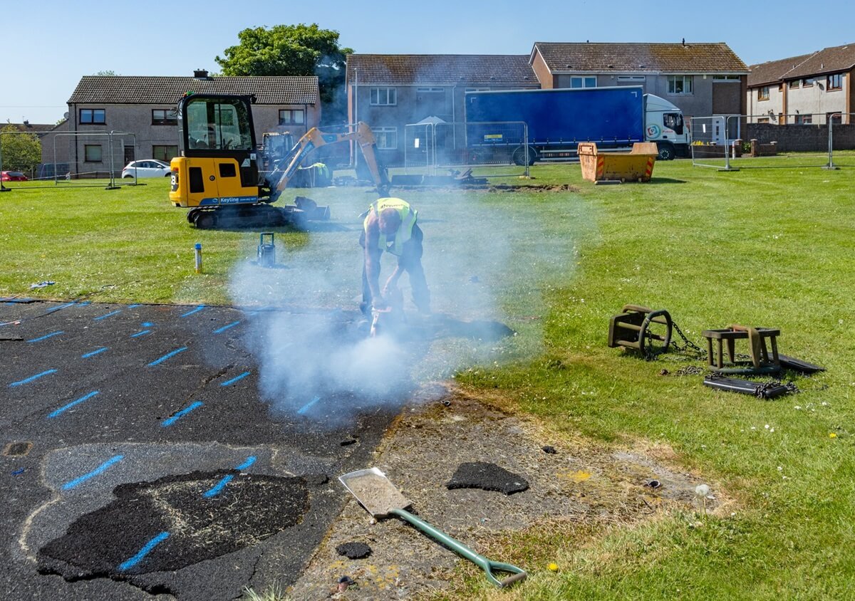 Work begins on new play area at Balgreggie, Cardenden Digger and man working on greenspace