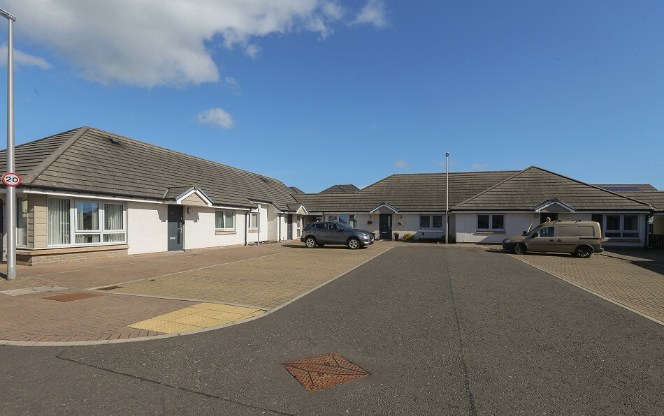 Exterior pictures of the Ostlers Way bungalows, showing the communal parking available