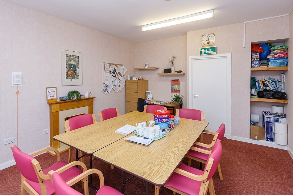 Communal dining and sitting area at Winthank Court, with games and puzzles available.