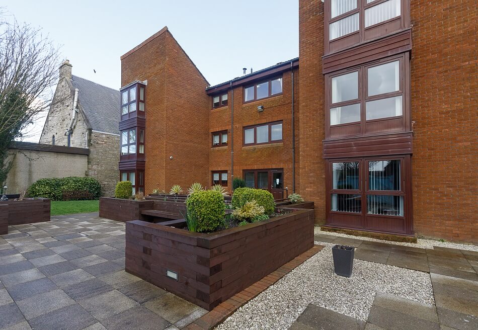Communal outdoor space, with planters and grassy area outside Spencer House