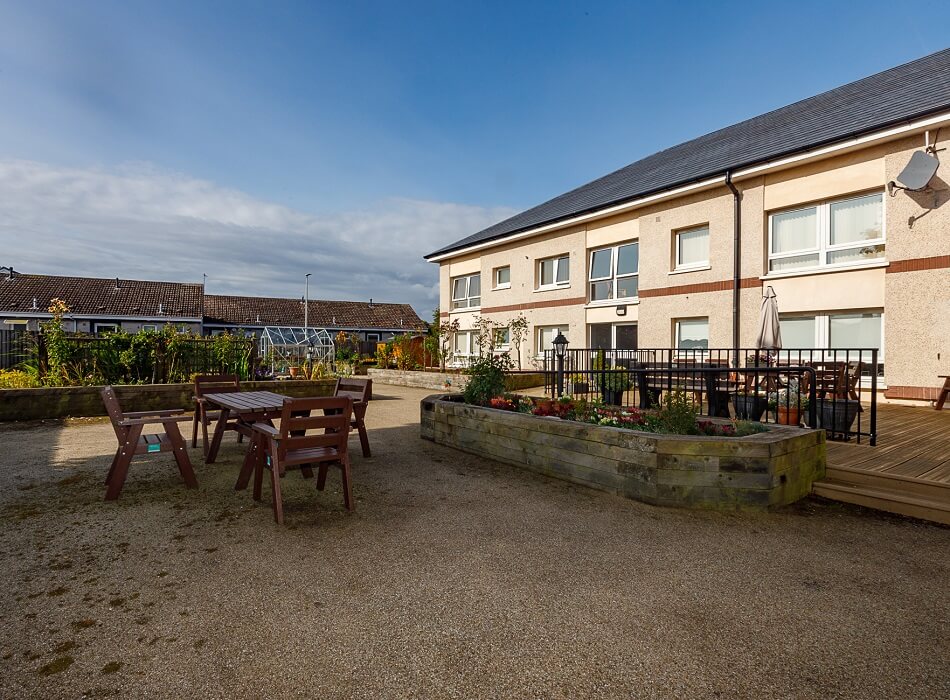 Communal outdoor seating area, with bench tables and decking area