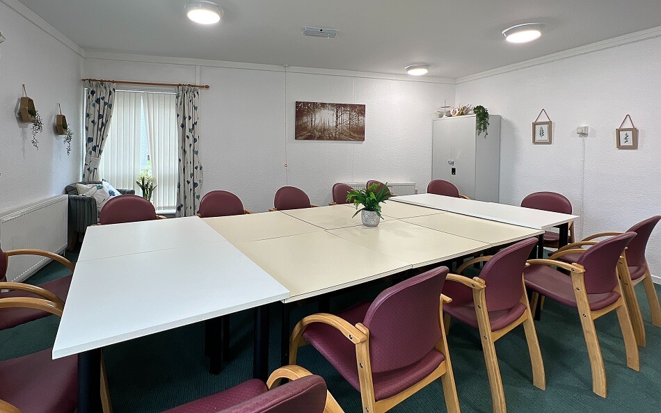 Communal dining area with long table and lots of chairs at Dollar Court