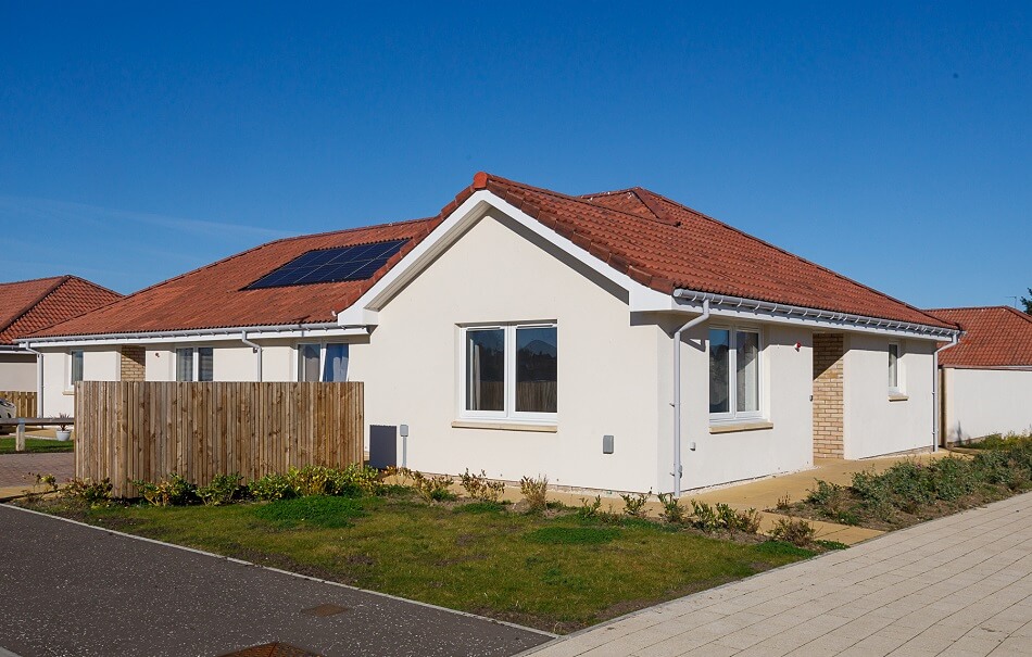 One of the bungalows at Methil Care Village, with white facade and red roof