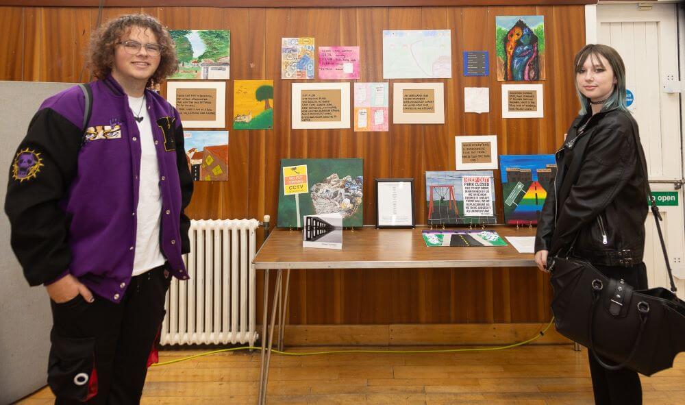Picture of NEF Youth Voice members with art on Display at the Rural Poverty Conference
