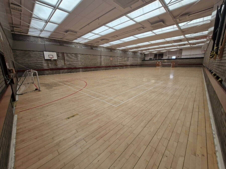 games hall A large indoor games hall. A wooden floor has court lines.