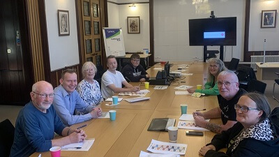 New Community led steering group to oversee how money will be spent in the Kirkcaldy area People sitting 'round a table in a meeting room. Papers and coffee cups are on the table