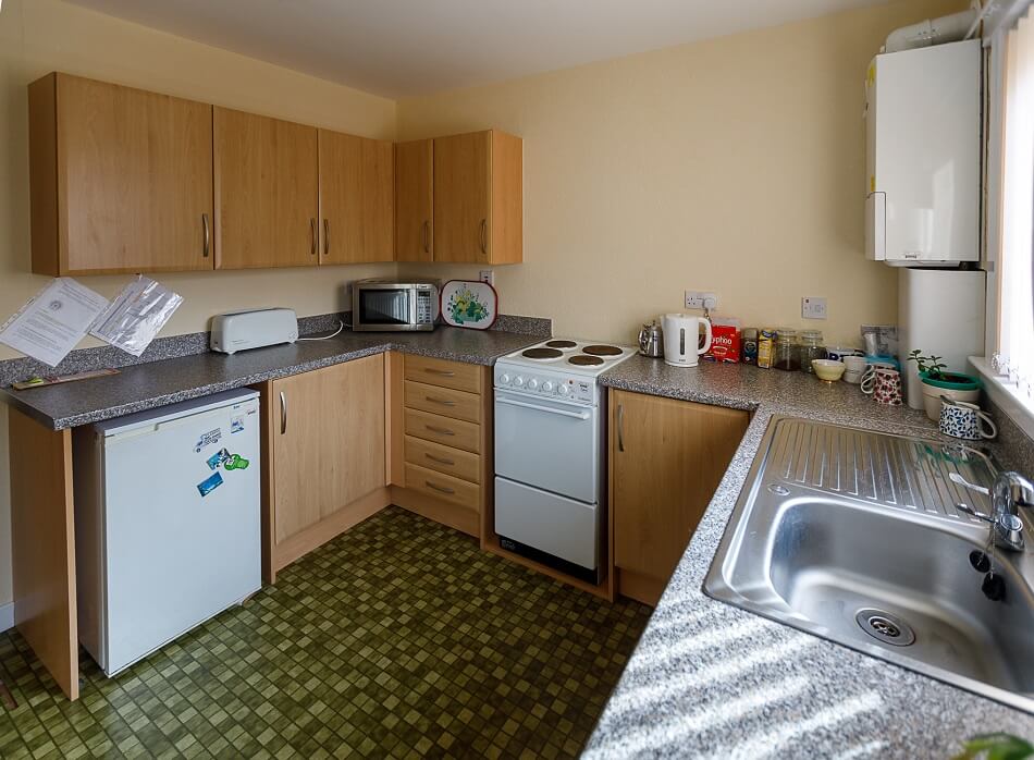 Communal kitchen at Castle Park, with sink area, fridge, and cooker