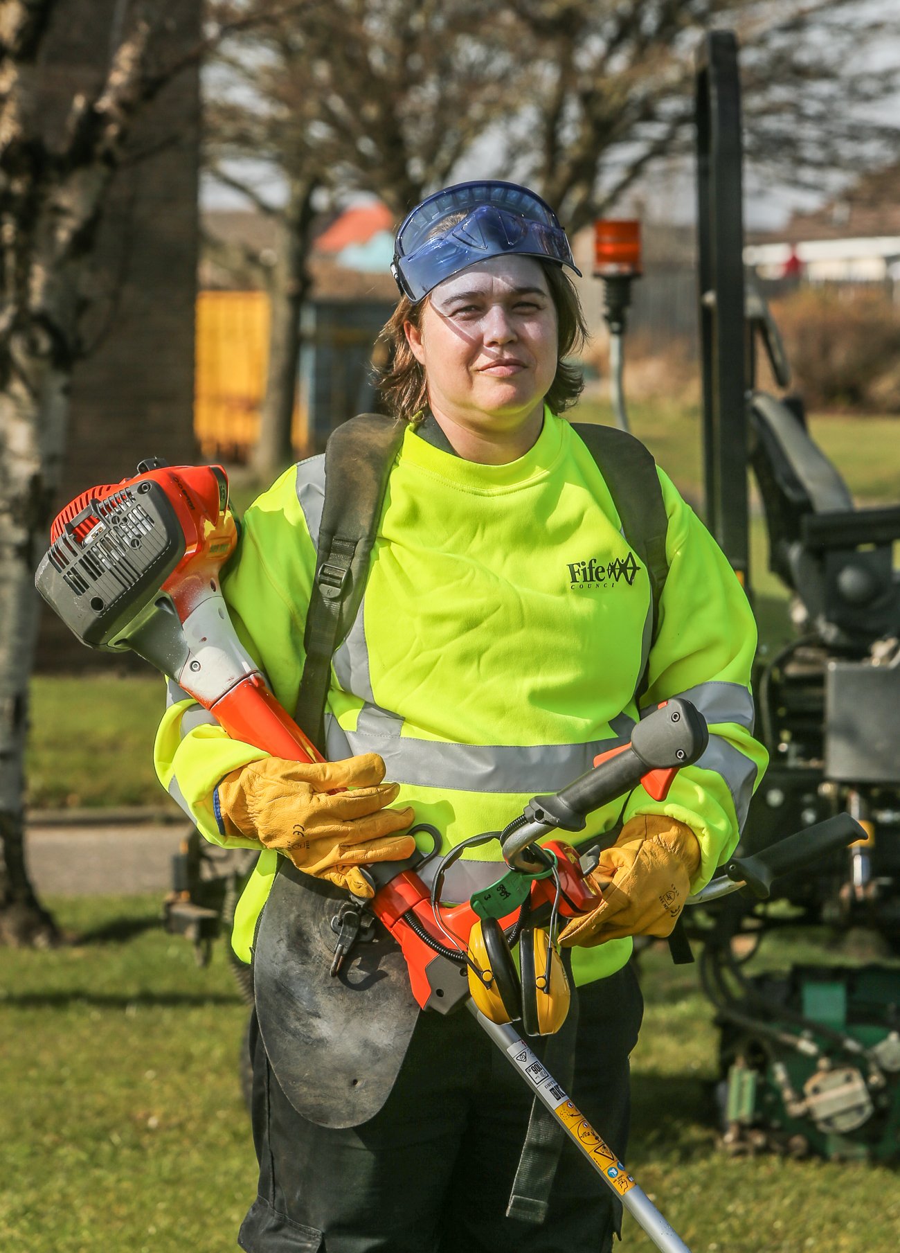 Lady with grass strimmer