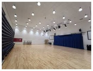 A gym with green walls and a wooden floor A gym with green walls and a wooden floor