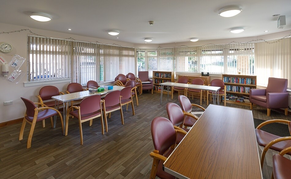 Dining area at Mears Court, with dining tables and chairs and reading corner