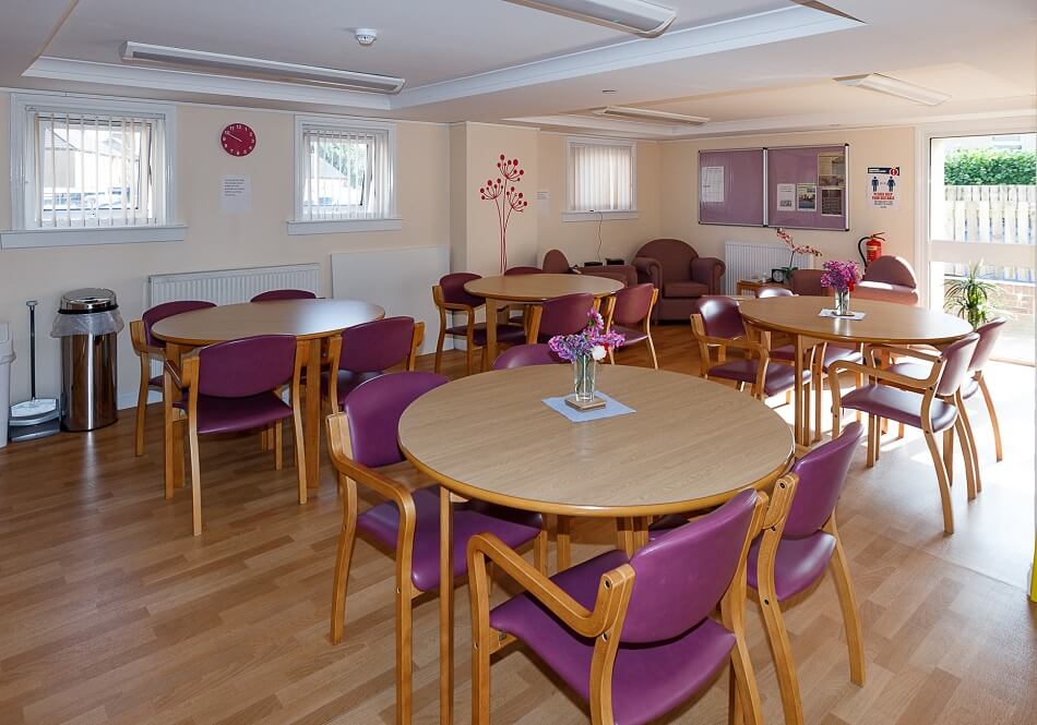Communal lounge and dining area, with several dining tables and chairs