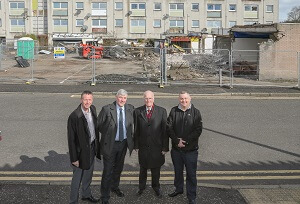 Demolition continues at the Glenwood Centre, Glenrothes Standing in front of the fenced off flats to be demolished - Norman Laird, Community Manager for Glenrothes; Cllr Altany Craik, Spokesperson for Finance, Economy and Strategic Planning , Cllr. Ross Vettraino, Depute Convener – Glenrothes Area Committee and Cllr. Craig Walker, Convener – Glenrothes Area Committee.