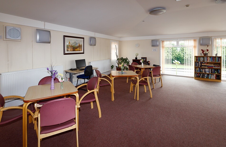 Tables and chairs, with reading area and computer at Graham Court
