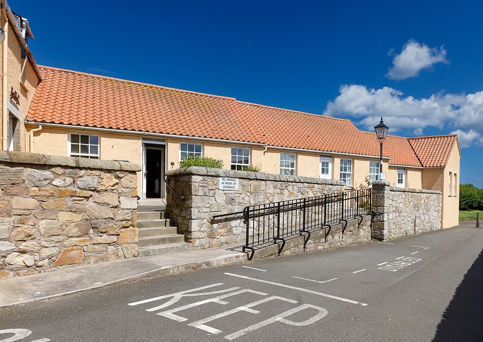Front entrance to the complex at Kirkhill, with parking and ramped walkway