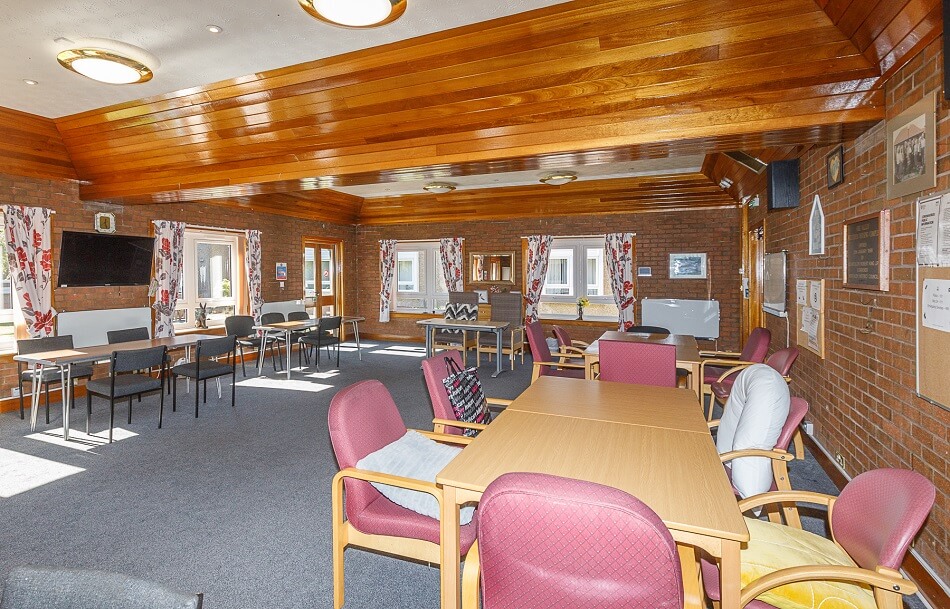 Communal dining and living space with tables and chairs