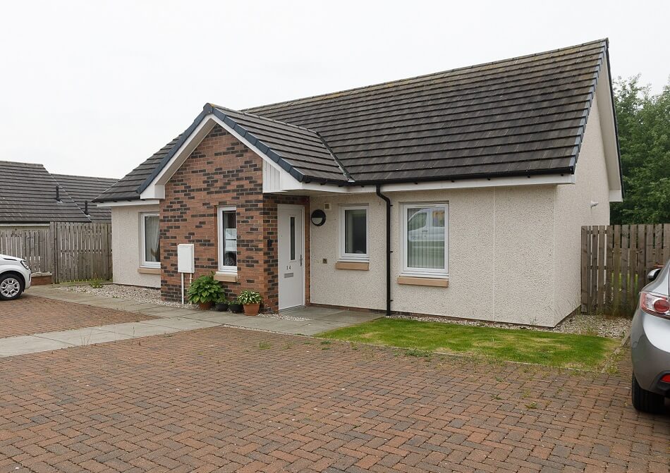 Example of a typical bungalow at Oakley with small garden to the front and parking