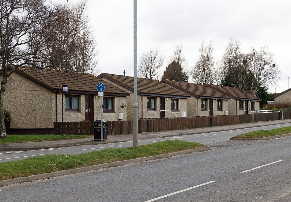 Row of bungalows, with public kerb to the front, that make up the Sea Road complex