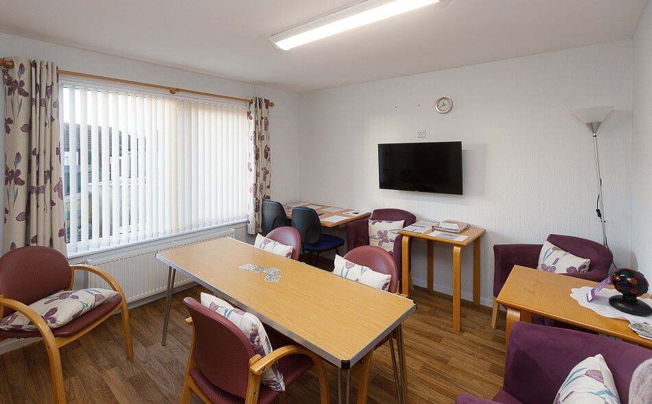 Seating and dining area at The Riggs, with communal TV
