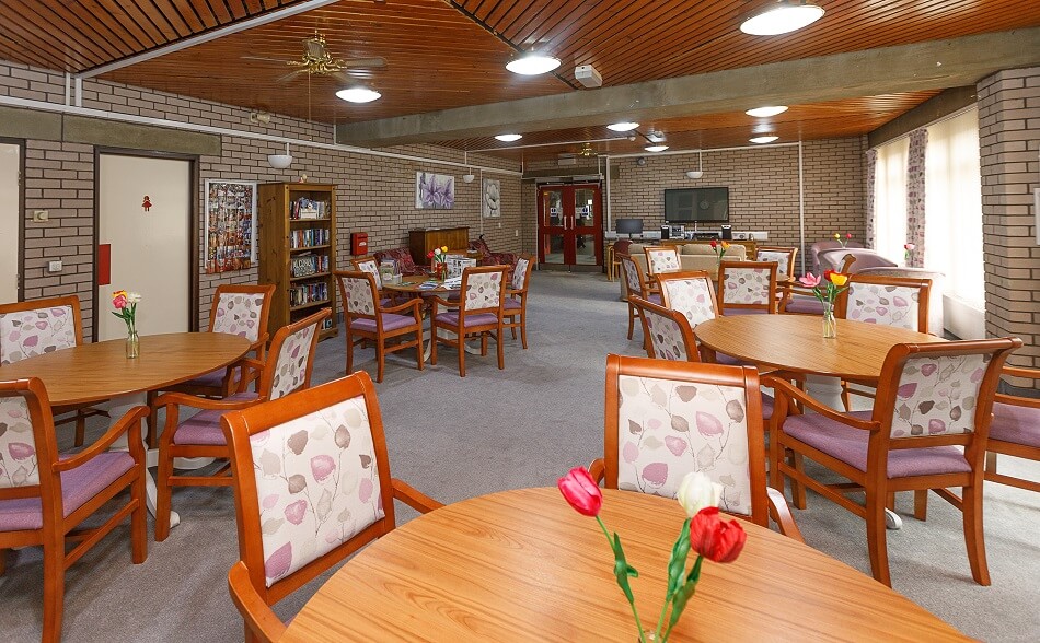 Dining and lounge area at Spencer House, with six individual tables of four.