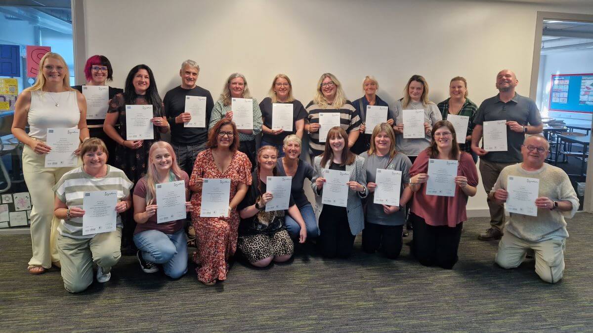 A group of BSL learners receiving certificates - Celebrating success in British Sign Language courses across Fife