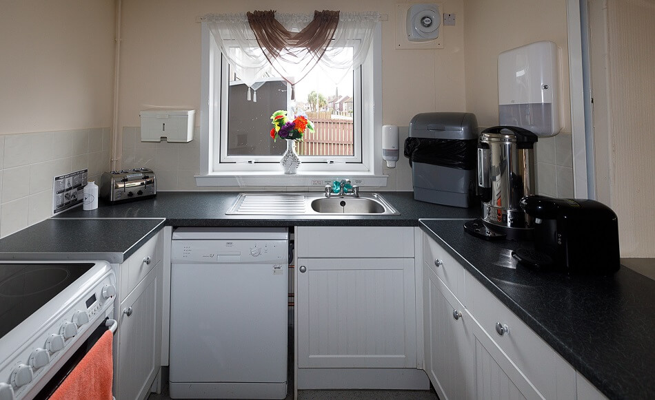 Communal kitchen with coffee facilities and meal prep area at Graham Court
