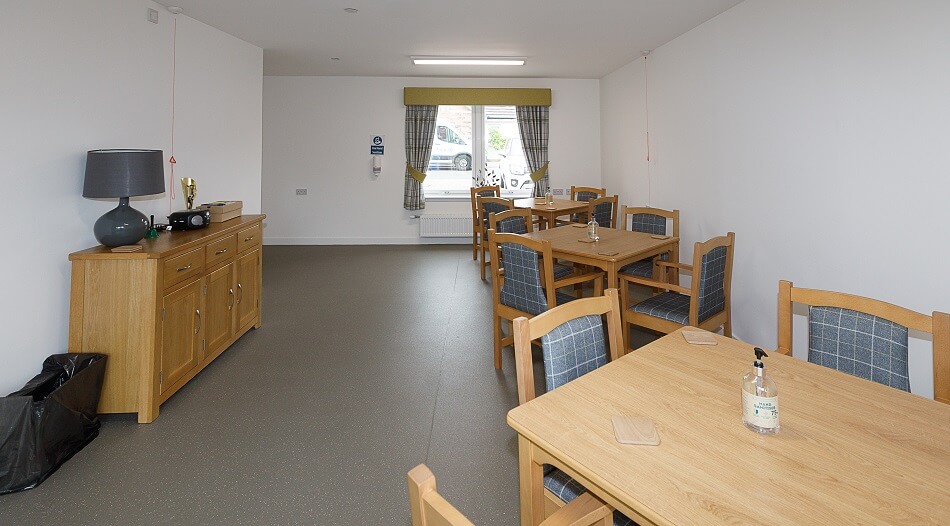 Communal dining area set with tables and chairs of four