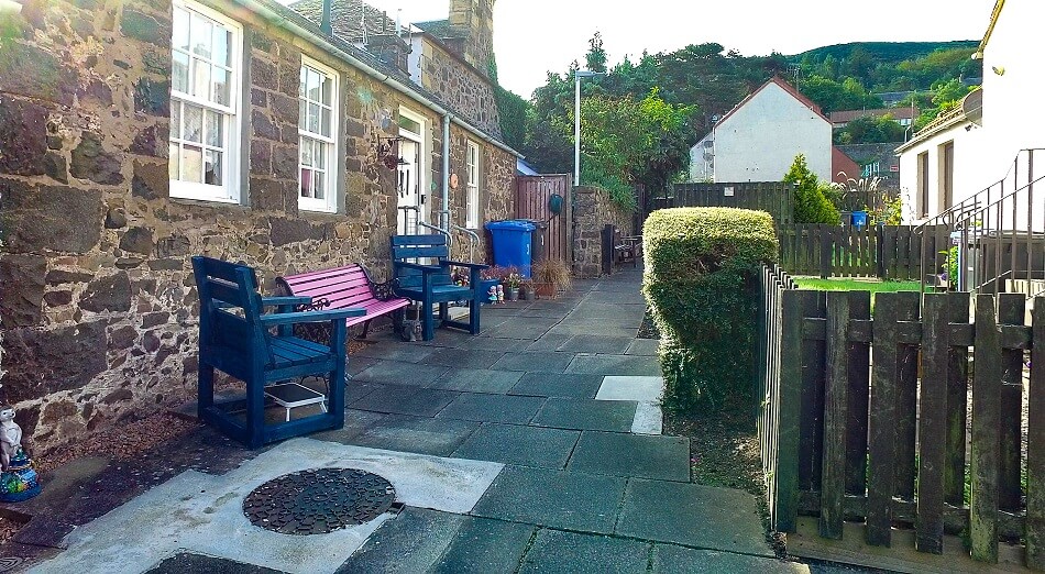 Communal outside seating area, with colourful benches