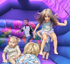 Bouncy-Castle.jpg Children playing and jumping inside a colourful inflatable bouncy castle