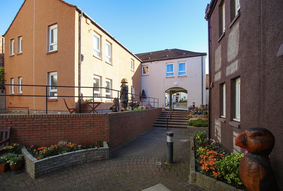 Communal paved area and planters to the rear of Harbourlea