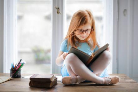 young girl reading a book