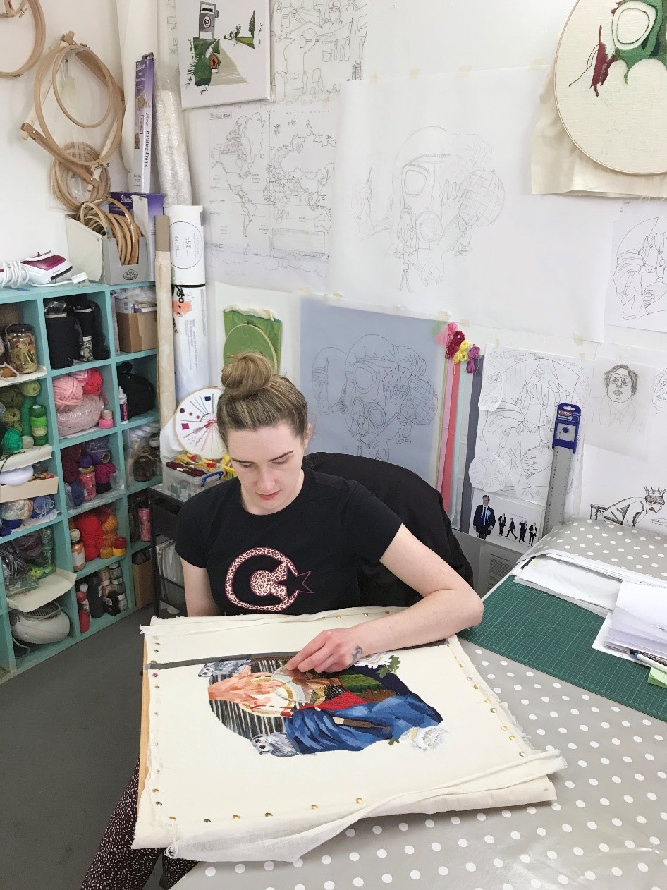 Photo of Nikkita working in her studio