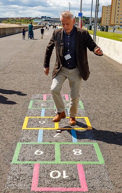 Kirkcaldy waterfront playground games 22 Man playing hopscotch