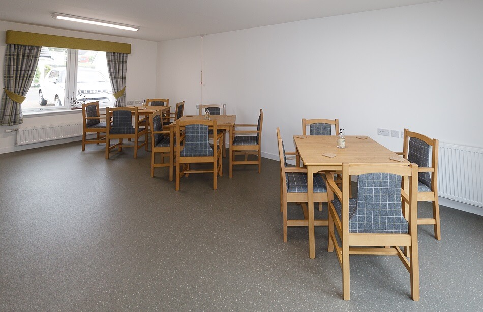 Large communal dining area with tables and chairs