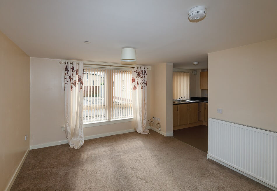 Lounge with large window within individual property at Byron Court