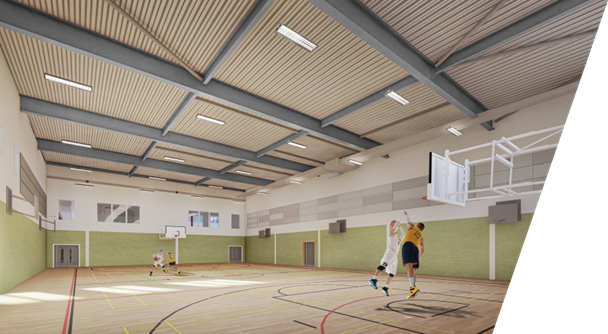 A bright indoor sports hall with a high wooden ceiling and court markings on a polished floor. A basketball hoop with a backboard is mounted on the right wall. Near the hoop, two players are jumping toward the basket while others move across the court in the background. The hall is spacious, with pale walls, green lower panels, and clear lines for multiple indoor sports.