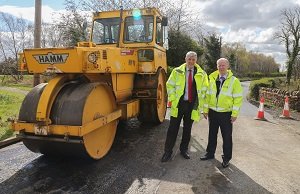 Steam roller on road with Cllr. Altany Craik & Alistair Donald, Roads & Transportation Services and John - Over £1.1m spent resurfacing roads since January
