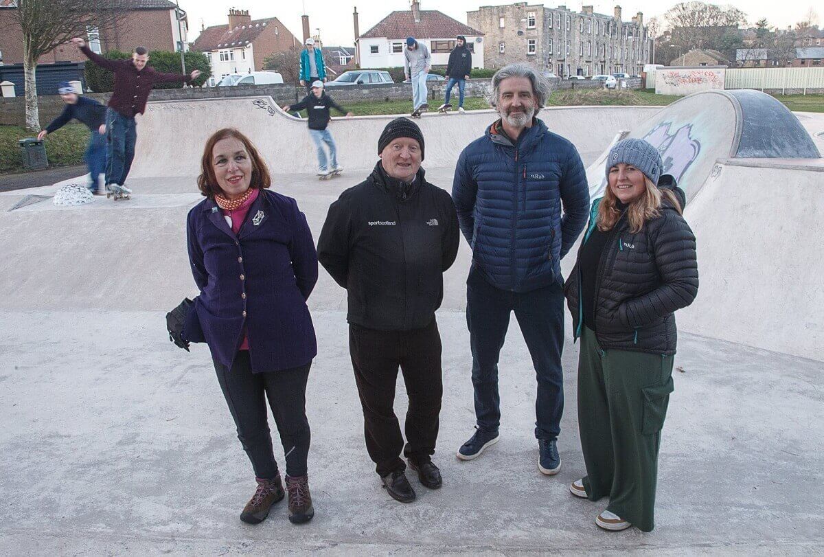Cllr Liston, Andrew Kelly, Adrian Wood and Jackie Flett with some of the young people involved in the project skateboarders in skate park