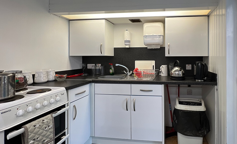 Communal kitchen with cooking and washing facilities at Dollar Court