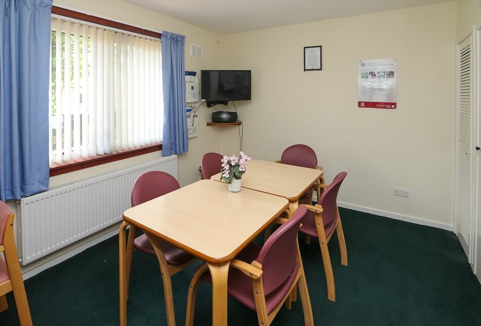 Communal living area at Elm Place, with table and four chairs