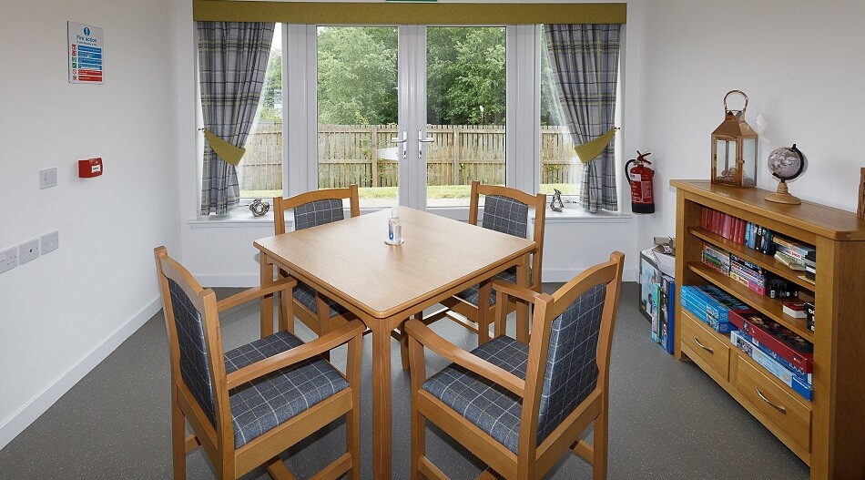 Tables and chairs set at Oakley, with views out to the garden