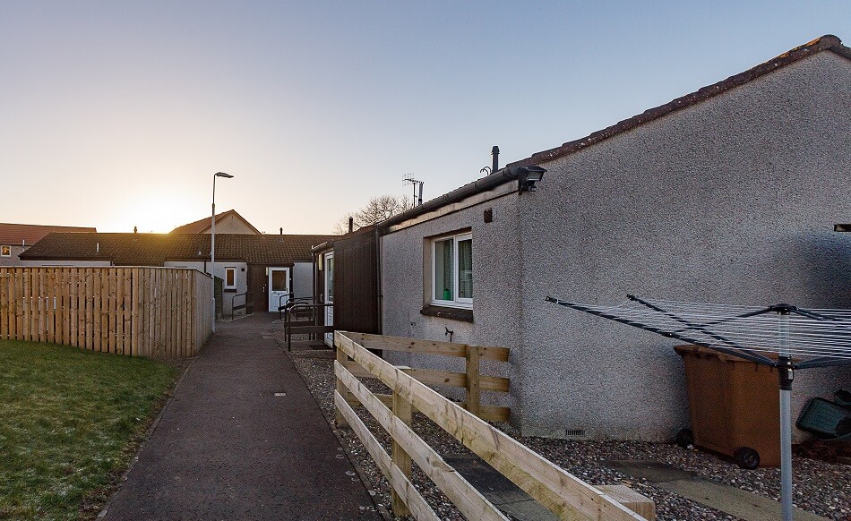 Exterior of a bungalow at The Riggs, with communal walkway