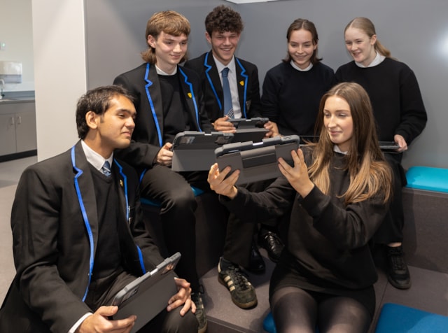 Fife school pupils with digital devices for illustrative purposes. - Council commits to raising educational attainment