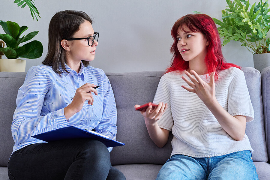 sw residential woman and teenager talking on sofa