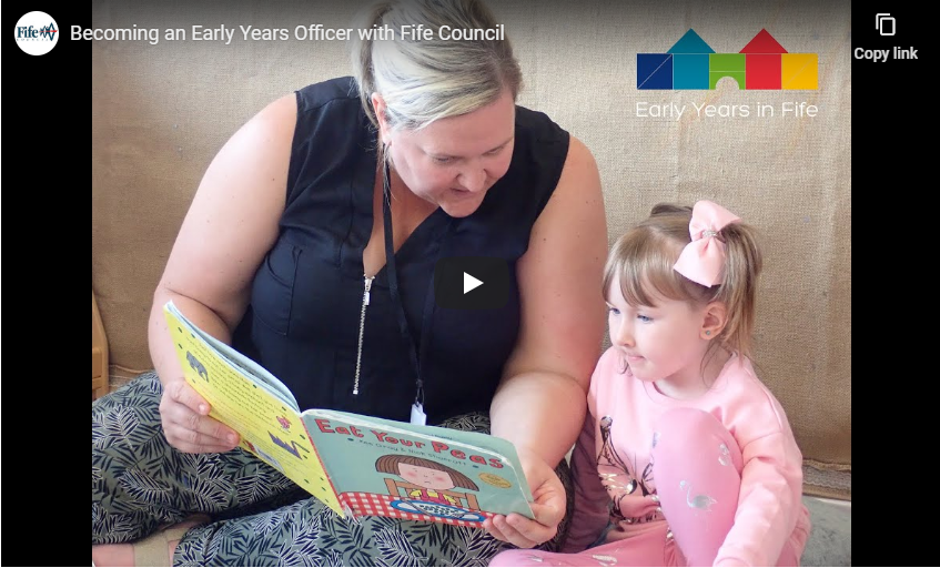 A woman reading from a story book to a child - Find out about Early Years Officer as a career